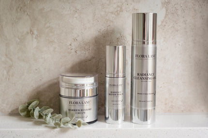 Flora Lane trio on marble — ceramide-rich Barrier Restore Cream for perimenopause skin