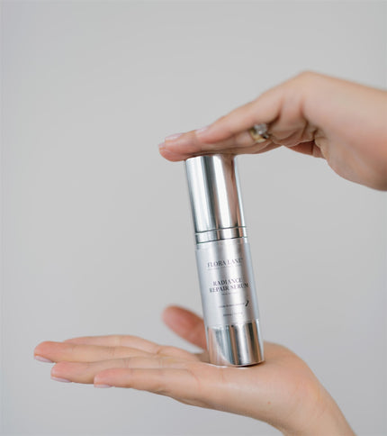 Hands cradling Flora Lane Radiance Repair Serum — daily skincare habits for perimenopausal skin